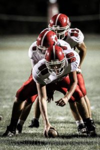 Center Kyle Watson (50), quarterback Brayden Miller (8), and in the back field Chandler Perkins (82) from Dexter in a game against Mattanawcook earlier in the season.